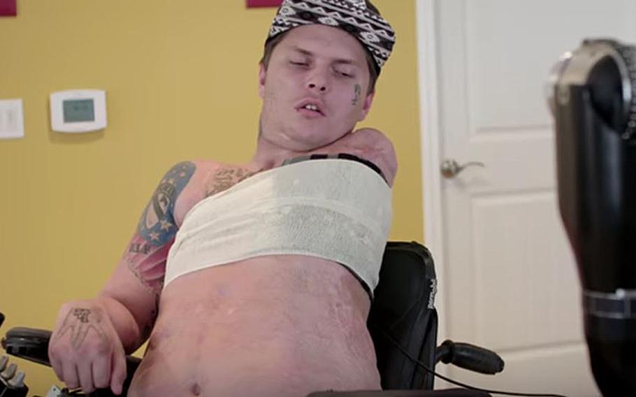 A video screen grab shows Army veteran Jerral Hancock, a paralyzed amputee, preparing to raise a prosthetic limb by thinking about the action.