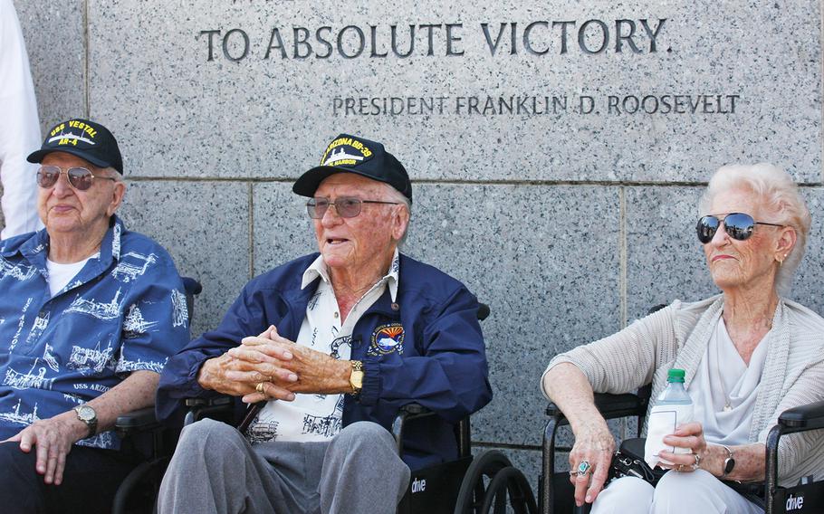 USS Arizona survivors Lauren Bruner, far left, and Donald Stratton, center, visit the World War II Memorial in Washington, D.C., on July 20, 2017. To the far right is Stratton's wife, Velma.  