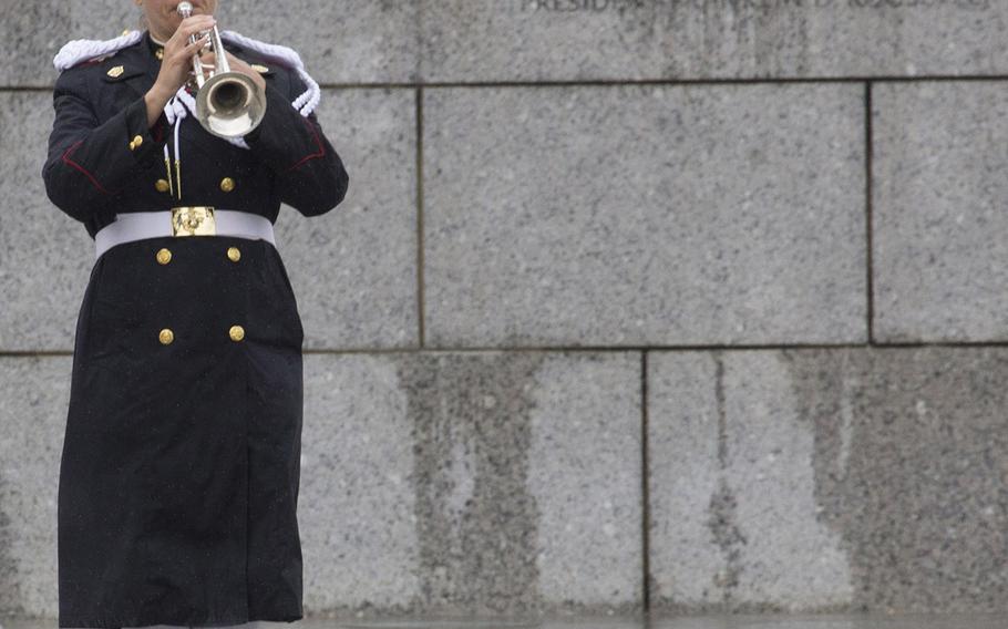 A bugler plays taps at a ceremony marking the 72nd anniversary of V-J Day, September 2, 2017 at the National World War II Memorial in Washington, D.C.