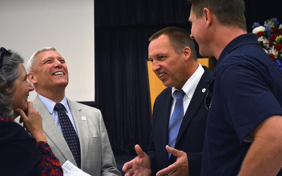 Retired Gen. Jon Paxton Jr. shares a laugh with Rick Yount, executive director of the Warrior Canine Connection, prior to the WCC's graduation ceremony on Oct. 7, 2017.