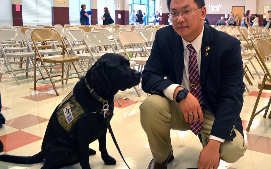 Retired Marine Sgt. Michael Boudreau poses with his sevice dog Tamer - named after Ret. Gen. John Amos - after the Warrior Canine Connection graduation on Oct. 7, 2017.