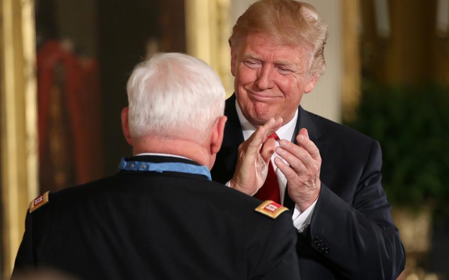 President Donald Trump applauds retired Army Capt. Gary M. Rose after presenting the former combat medic the Medal of Honor at a White House ceremony held Oct. 23, 2017. 