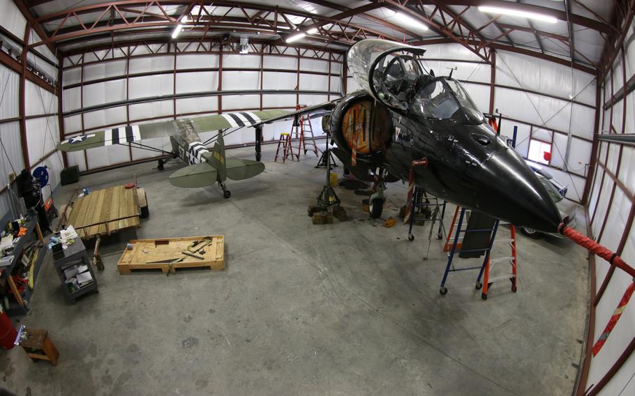 A Piper L-4 Cub and a L-39C Albatros sits in a hanger in southern Maryland. Both aircraft belong to Art Nalls, a retired Marine test pilot turned air show performer. 