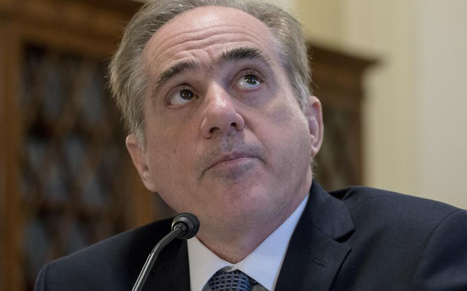 Former VA Secretary David Shulkin looks up at a chart on a monitor during a House Veterans' Affairs Committee hearing on Capitol Hill, Feb. 6, 2018.