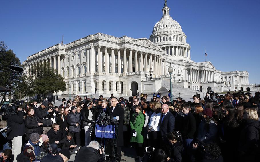 Rep. Ted Deutch, D-Fla., speaks at the podium where he is joined by students and parents from Marjory Stoneman Douglas High School, in Parkland., Fla., Friday, March 23, 2018, during a news conference about gun violence on Capitol Hill in Washington, ahead of the Saturday March For Our Lives.