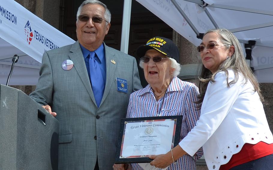 Anna Gatti, a Navy veteran of World War II, receives a plaque commemorating her as the honorary guest of Texas’s first Women Veterans Day event on the steps of the Texas State Capitol on June 12, 2018. On her left is Texas Veterans Commission Chairman Eliseo “Al” Cantu Jr., and on her right is Texas Veterans Commission Women Veterans Program Manager Anna Baker.