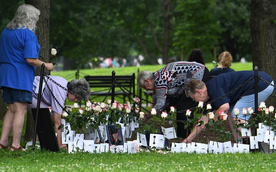 About 3,000 roses were placed at the Vietnam Memorial Wall in Washington, D.C., as part of the annual Father's Day Rose Remembrance. White roses with red tips symbolize "In memory" honorees - Vietnam veterans who died after the war from war related causes. This was near The Three Soldiers.