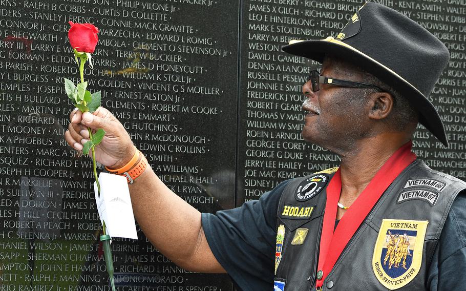 Johnnie Downs places one of about 3,000 roses at the Vietnam Memorial Wall in Washington, D.C., as part of the annual Father's Day Rose Remembrance. 
