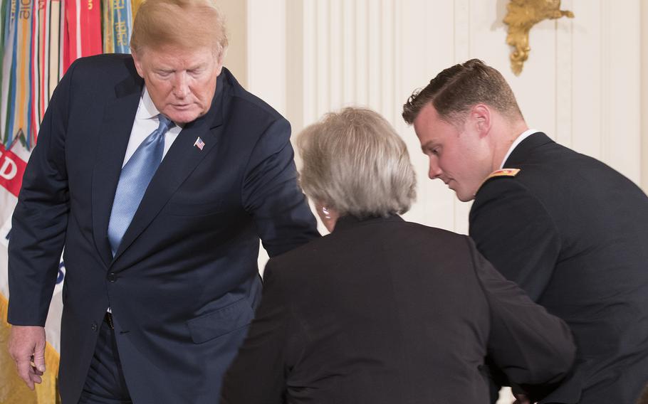 President Donald Trump awarded the nation’s highest military decoration to Garlin “Murl” Conner’s widow, Pauline, in a White House ceremony June 26, 2018. Here, President Trump helps Pauline onto the stage. 