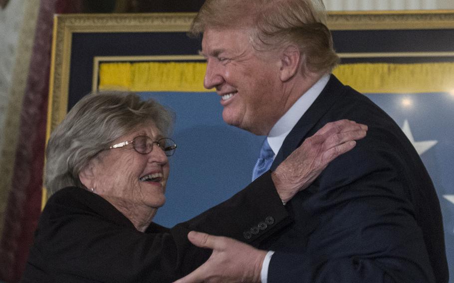 President Donald Trump hugs Pauline Conner, widow of Garlin "Murl" Conner, as she accepts the Medal of Honor for her husband. Garlin Conner, a WWII Army lieutenant, was posthumously awarded the Medal of Honor on June 26, 2018.