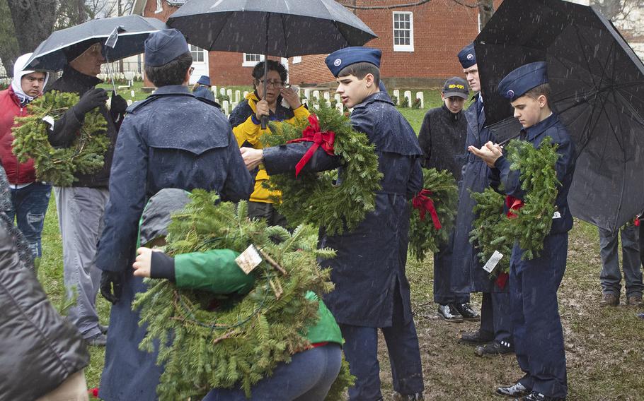 Volunteers take wreaths to place at graves at The US Soldiers' and Airmen's Home National Cemetery during Wreaths Across America on Dec. 15, 2018, in Washington, D.C.

