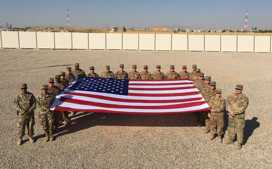 Soldiers of the 184th Sustainment Command, serving in the 1st Theater Sustainment Command's Syrian Logistics Cell, gather for a Fourth of July photo in Irbil, Iraq.