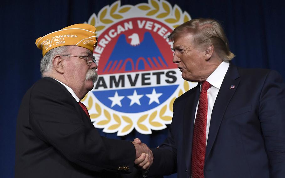 President Donald Trump greets AMVETS national commander Rege Riley at the American Veterans 75th National Convention in Louisville, Ky., Wednesday, Aug. 21, 2019. 