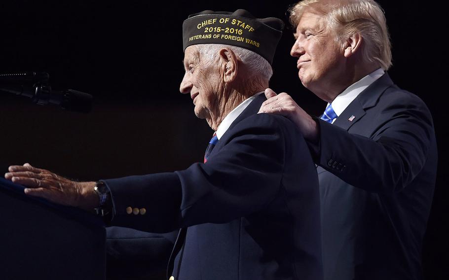 President Donald Trump honors World War II veteran Allen Q. Jones on Tuesday, July 24, 2018, by inviting the 94-year-old onto the stage at the VFW convention in the Kansas City, Mo., Municipal Auditorium.