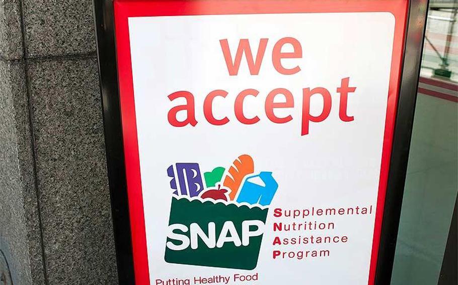 A sign indicates a store that accepts the Supplemental Nutritional Assistance Program or SNAP, the official name of the food stamp program.