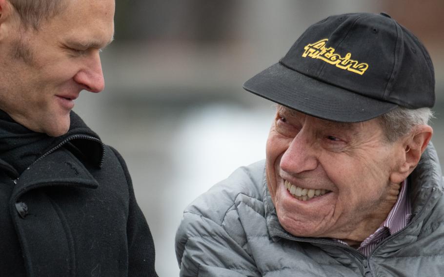 World War II veteran George Arnstein, right, chats with a member of the Belgium delegation during the National World War II Memorial's Battle of the Bulge 75th Anniversary Commemoration, December 16, 2019. 