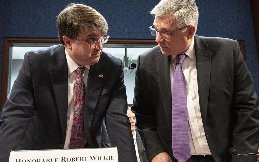 Secretary of Veterans Affairs Robert Wilkie, left, talks with Veterans Health Administration Executive in Charge Dr. Richard Stone before a House Veterans' Affairs Committee hearing on Capitol Hill, Feb. 27, 2020.
