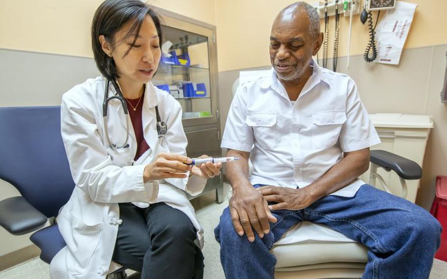 A Department of Veterans Affairs doctor speaks with a patient in this undated file photo.