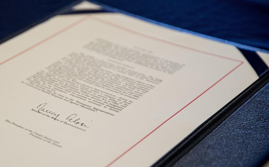 The signature of House Speaker Nancy Pelosi on the Coronavirus Aid, Relief, and Economic Security (CARES) Act document on Capitol Hill, Friday, March 27, 2020.