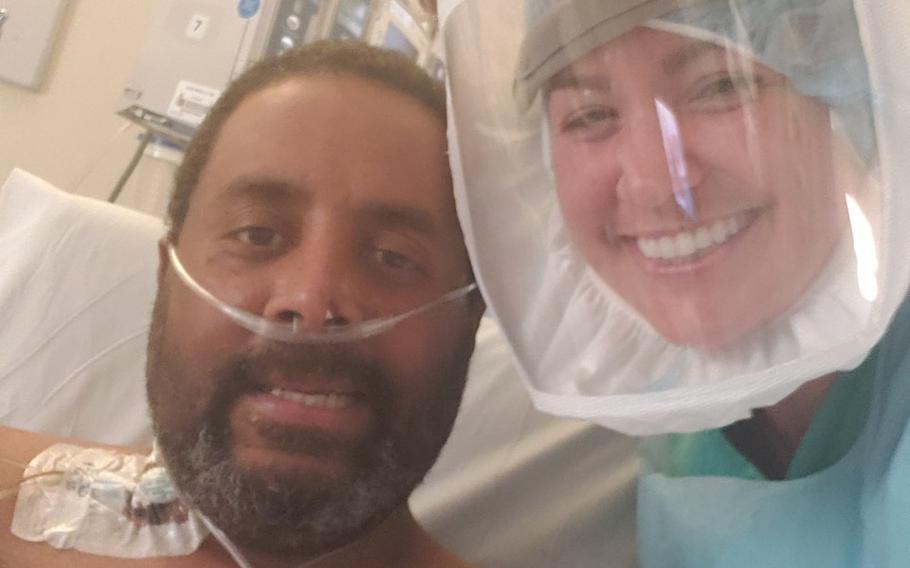 Marine Corps veteran David Williams with his nurse, Melanie Bryant, at the John L. McClellan Memorial Veterans Hospital in Little Rock, Ark. Medical staff lined the hallways and cheered for Williams as he was released from the hospital April 9. Williams was diagnosed with the coronavirus and spent eight days on a ventilator. 