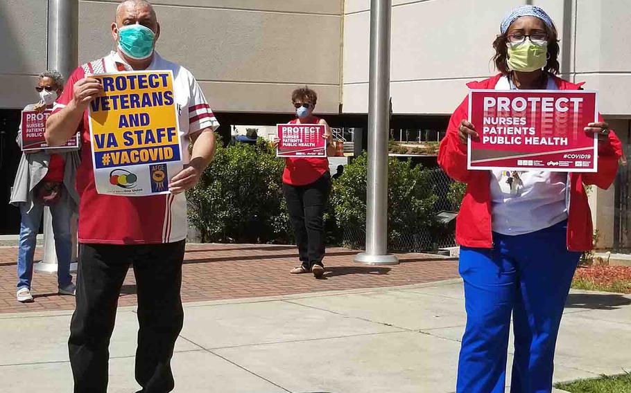 Between shifts, medical staff at the Atlanta VA Medical Center protest the hospital's rationing of personal protective equipment, Friday, April 17, 2020.