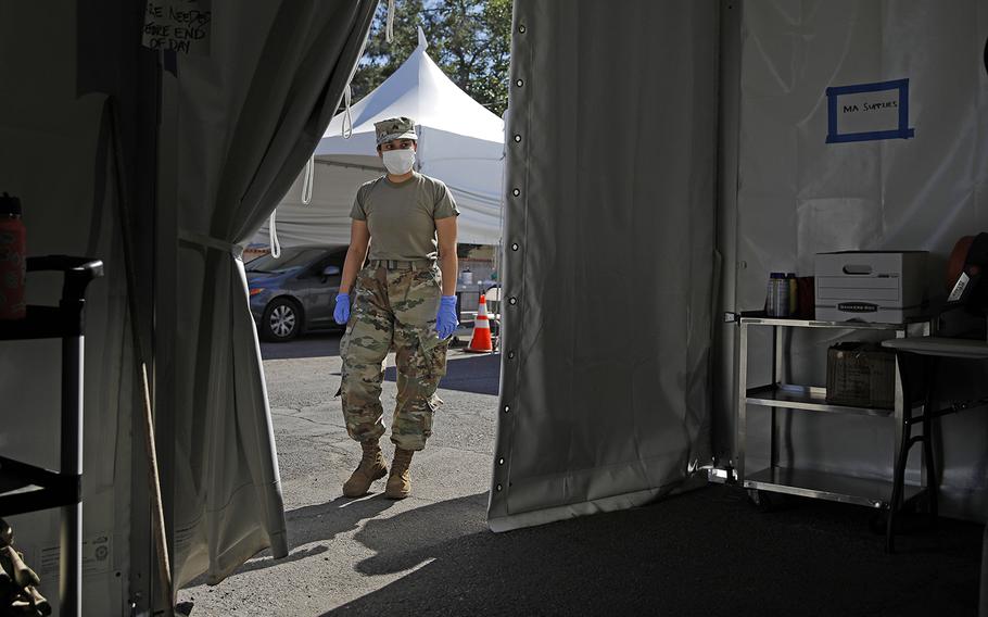 A member of the Nevada Army National Guard works at a drive-thru coronavirus testing site Tuesday, April 28, 2020, in Las Vegas. 