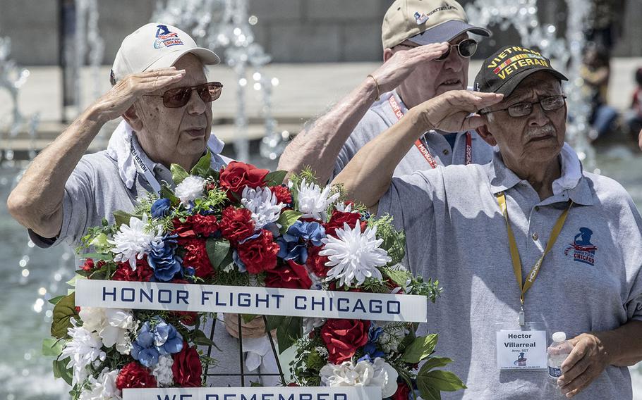 Honor Flight Chicago veterans salute during a ceremony honoring them at the National World War II Memorial in Washington, D.C. on July 10, 2019.