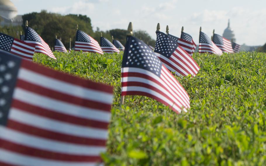 Thousands of American flags fill a grassy expanse on the National Mall in October 2018, each representing a veteran or a servicemember who died by suicide in 2018. The 5,520 flags were placed on the Mall by Iraq and Afghanistan Veterans for America, an advocacy group trying to draw awareness to the issue of veteran suicide.