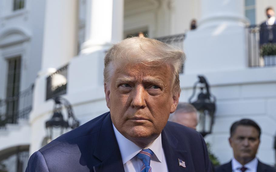 President Donald Trump leans in to hear a question as he speaks with reporters before walking to Marine One on the South Lawn of the White House, Wednesday, July 29, 2020, in Washington.