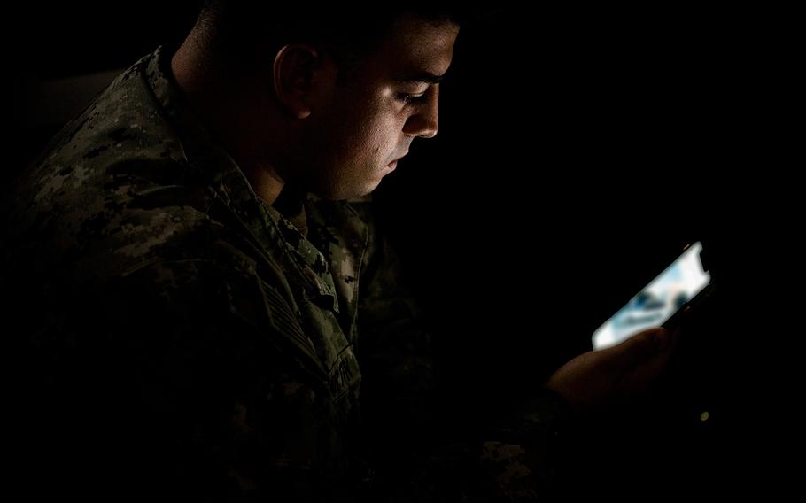 Petty Officer 2nd Class Jancarlo San Martin, assigned to Naval Station Rota, Spain, looks at a cellphone on Sept. 18, 2020.