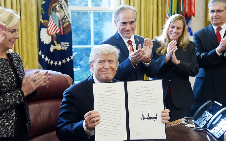 President Donald Trump holds a signed Executive Order on "Supporting our Veterans during their Transition from Uniformed Service to Civilian Life" on Tuesday, January 9, 2018 in the Oval Office of the White House in Washington, D.C.