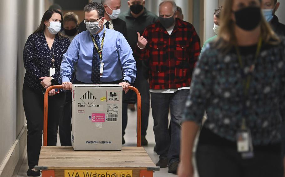 Minnesota Gov. Tim Walz follows the first delivery of the Pfizer-BioNTech COVID-19 vaccines into the Minneapolis VA Hospital, Monday, Dec. 14, 2020. 