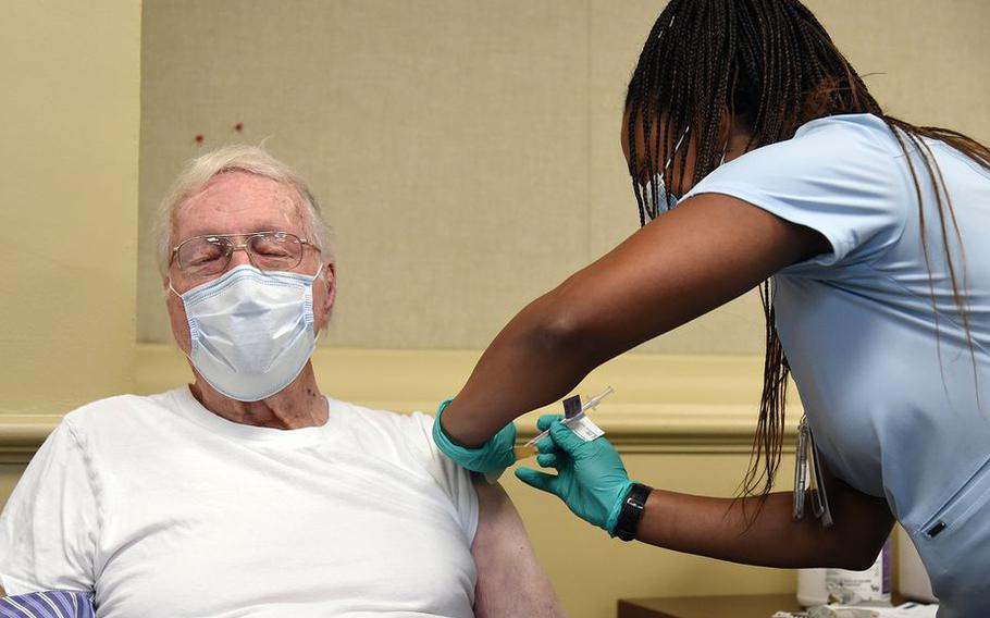 World War II veteran Lee Elm Creel, 94, of Snow Town, Alabama gets his vaccine from Precious Reynolds, an RN at the Birmingham VA Medical Center in Alabam