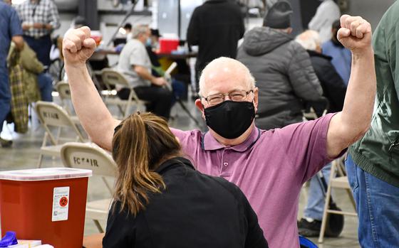 Vietnam War veteran Ben Bruso, 77, throws his fists up in celebration before receiving his second dose of the Moderna coronavirus vaccine on Tuesday, March 2, 2021. The Department of Veterans Affairs vaccinated 529 veterans at the event, which was held at the Flathead County Fairgrounds in Kalispell, Montana. 