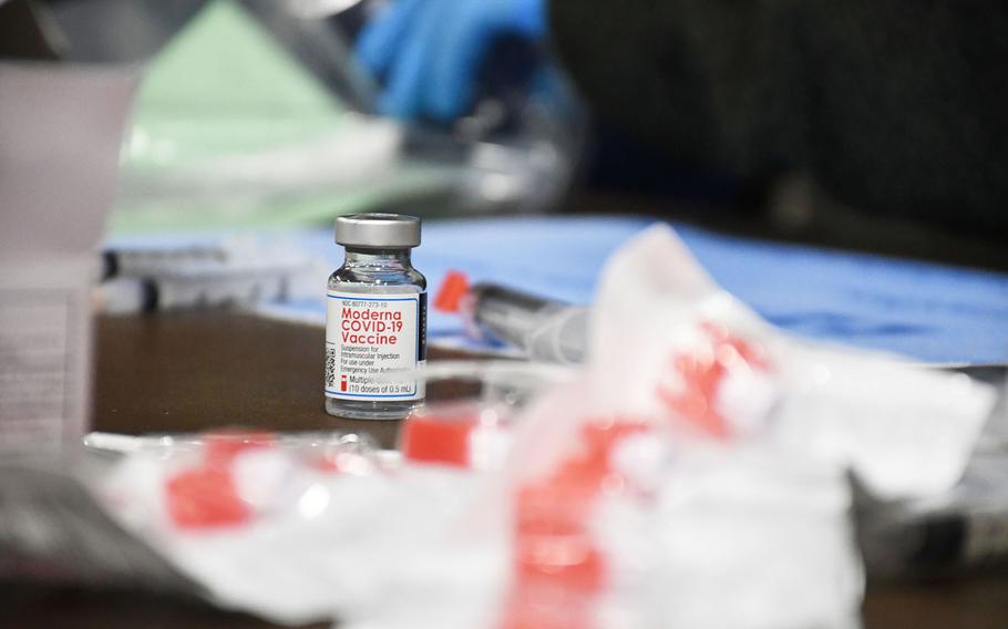 A vial of the Moderna coronavirus vaccine is surrounded by syringes at the Department of Veterans Affairs vaccination clinic in Kalispell, Montana, on Tuesday, March 2, 2021.
