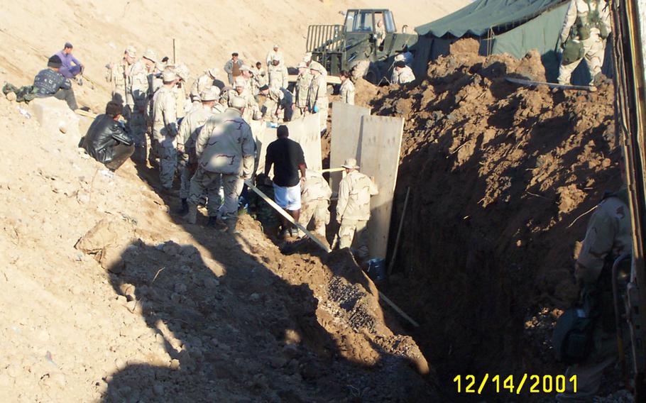 U.S. troops and Uzbek workers help build Camp Stronghold Freedom at Karshi-Khanabad Air Base in Uzbekistan in 2001. Hundreds of U.S. troops who served at the base, known as K2, between 2001 and 2005  have been diagnosed with cancer, but the Department of Veterans Affairs has said it does not have enough proof to link their illnesses with exposure to toxins at the base.  

