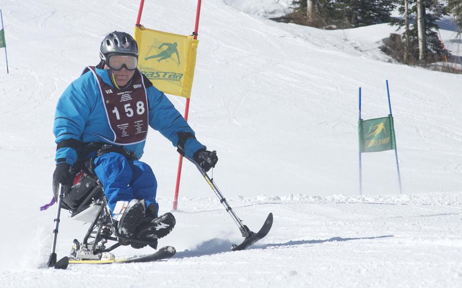 A veteran passes a gate during a race at the annual National Disabled Veterans Winter Sports Clinic at Aspen Snowmass Resort in Colorado in April 2015. Care for severely injured veterans has improved dramatically during the post-9/11 wars in Iraq and Afghanistan as has technology, allowing many with amputations and paralysis thrive in sports such as skiing and sled hockey, both of which are offered at the clinic.