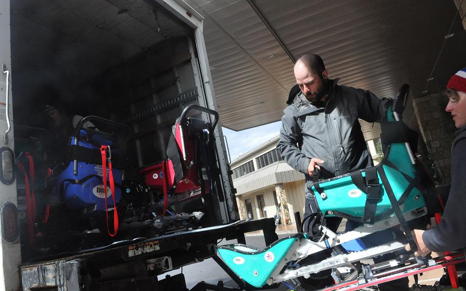 A volunteer loads sit-down skis designed for paralyzed athletes during the annual National Disabled Veterans Winter Sports Clinic at Aspen Snowmass Resort in Colorado in April 2015. More than 300 veterans attended the clinic, which is aimed at aiding their rehabilitation.