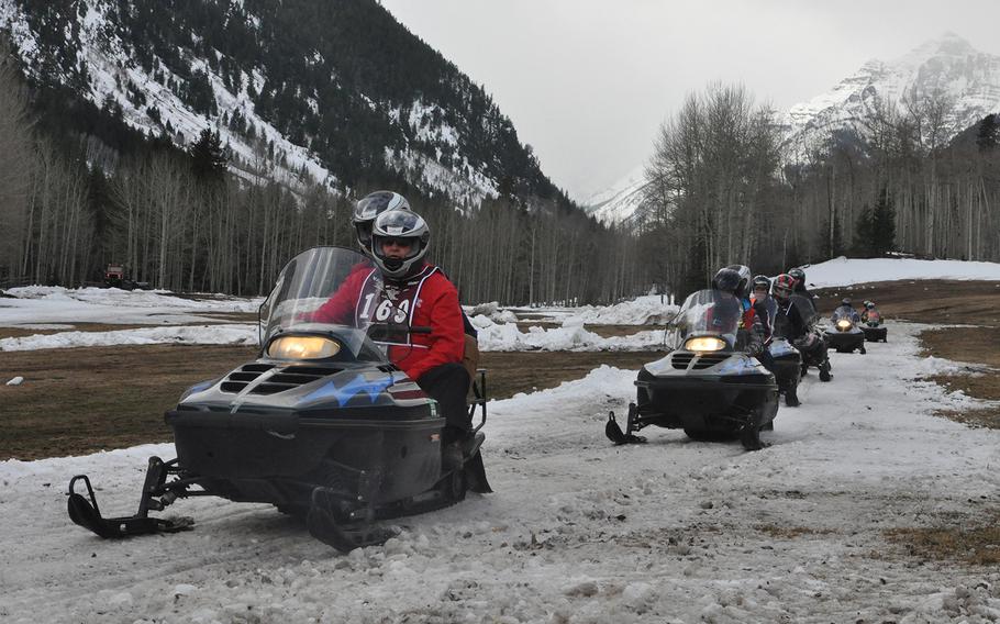With 14,018-foot Pyramid Peak in the background, wounded veterans brave bare conditions to snowmobile during the National Disabled Veterans Winter Sports Clinic in Colorado's Rocky Mountains in April 2015.
