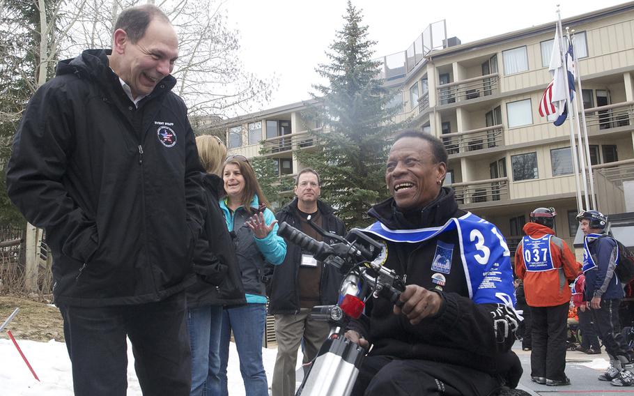 VA Secretary Bob McDonald, left, speaks with Marine veteran Jake Hipps during the National Disabled Veterans Winter Sports Clinic at Aspen Snowmass Resort in Colorado in April 2015. McDonald said programs such as the clinic are vital to the health of severely disabled veterans.