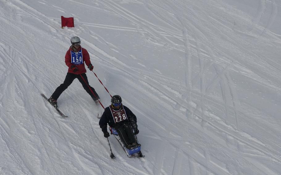 An instructor guides a veteran during a ski lesson at the National Disabled Veterans Winter Sports Clinic at Aspen Snowmass Resort in Colorado in April 2015. More than 300 veterans with injuries such as paralysis, blindness and traumatic brain injury participated in the clinic.