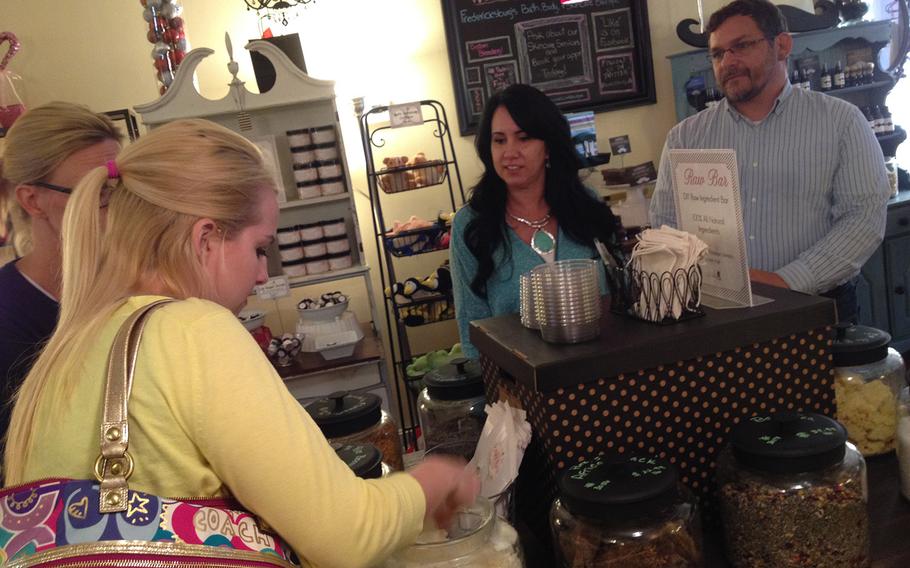 Fred an Crystal Wellman look on as customers peruse their soap at Ladyburg Apothecary, the boutique shop they co-own in Fredericksburg, Va. Wellman, a former Army scout, is one of the many veterans who have started their own businesses in the greater Washington, D.C.-metro area.