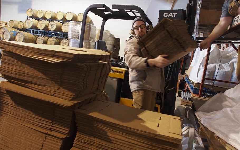 Heritage Brewing Co. head brewer Bo Elliot, an Army veteran, moves boxes at the Mannasas, VA, brewery, a veteran-owned company where more than 70 percent of employees have served in the Armed Forces.