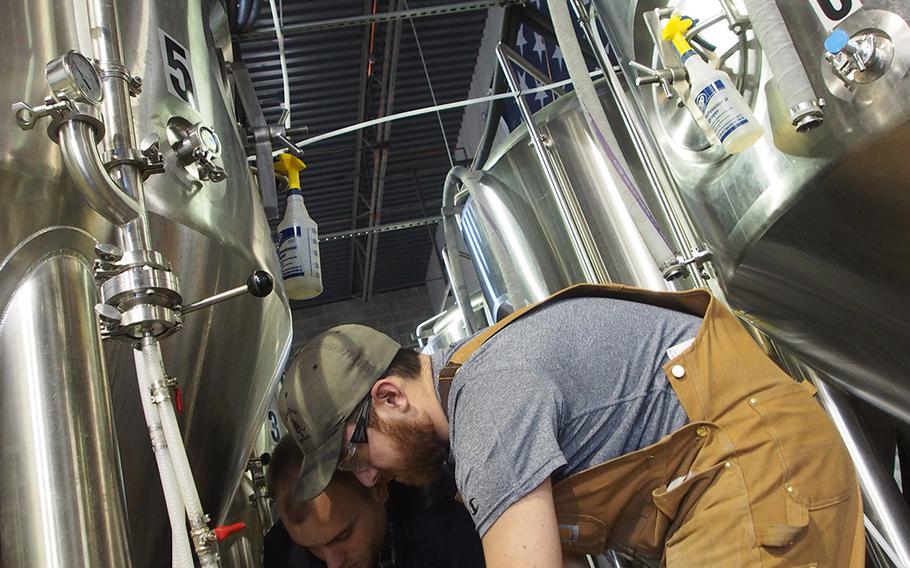 Marine veteran Sean Arroyo, foreground, and Chris Hampel, check equipment at Arroyo???s brewery, Heritage Brewing Co., in Manassas, VA, outside of Washington, DC. The Capital and surrounding area is a hot spot for veteran entrepreneurship.