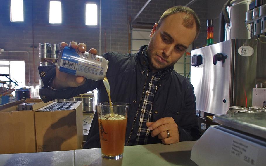 Sean Arroyo, an Iraq War veteran, pours a beer at his brewery, Heritage Brewing Co., in Manassas, Va. More than 70 percent of the staff at Heritage are veterans. 