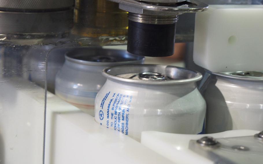 Cans run through a production line at Heritage Brewing Co., a veteran-owned brewery in Manassas, VA.