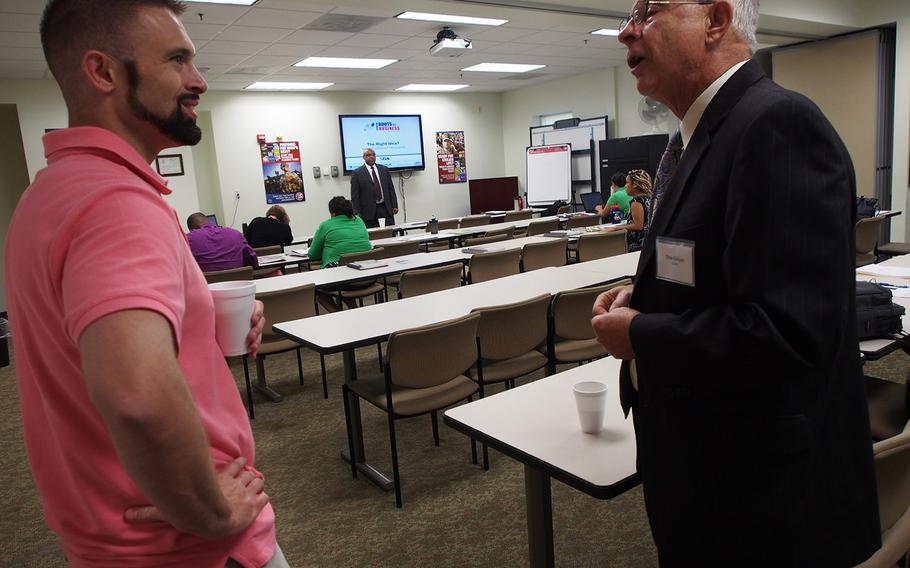 Navy veteran Nick Rudasill speaks with Stewart Gloyer, a former corporate executive who now mentors would-be entrepreuners with the SCORE group, during a Boots to Business session at Marine Corps Base Quantico. The program is aimed at helping troops and veterans lay the foundation for starting small businesses.