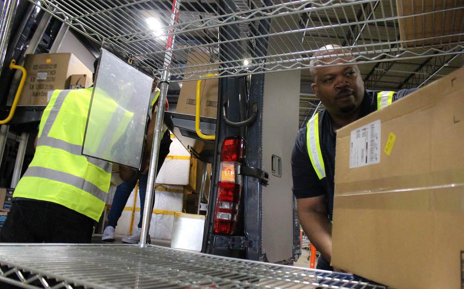 Retired Army Maj. Quinton Burgess (right) helps load items into his truck to be delivered at an Amazon shipping plant in Richmond, Va. Burgess and his Alligiance Logistics LLC company has partnered with Amazon as part of a program that helps veterans become entrepreneurs.