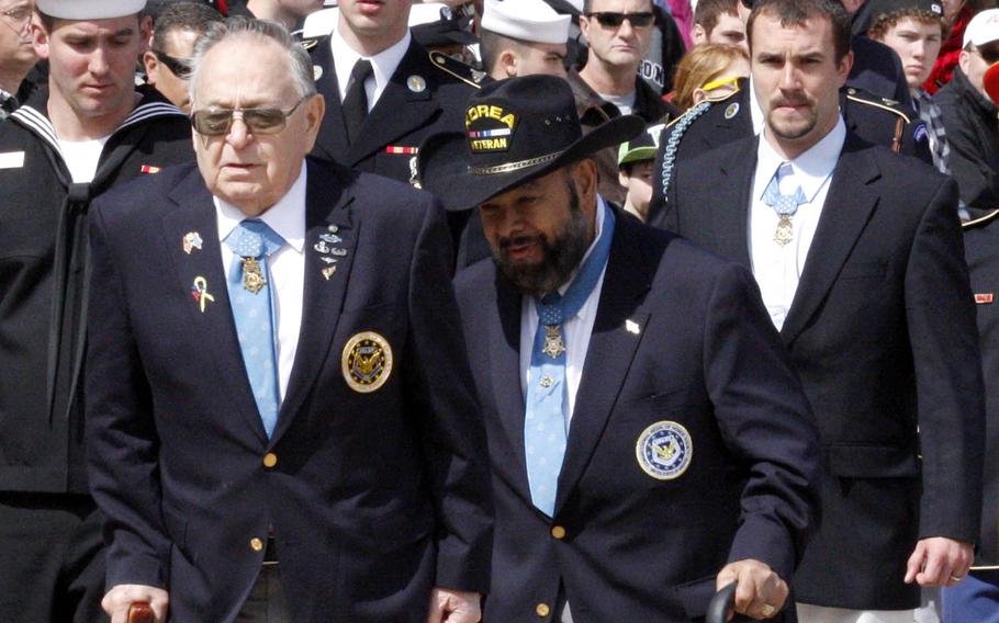Medal of Honor recipients Ronald Rosser, left, Rodolfo Hernandez, center, and Salvatore Giunta leave a wreath-laying ceremony at Arlington National Cemetery, March 25, 2011. Stars and Stripes