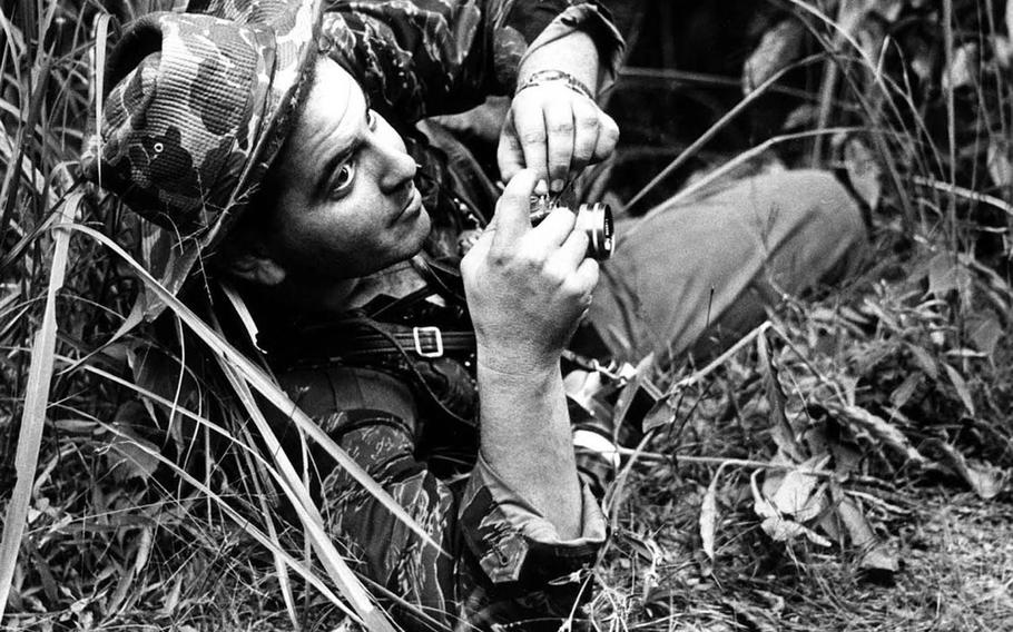 Former Stars and Stripes combat correspondent Steve Stibbens at work during an ambush in Vietnam in 1963.